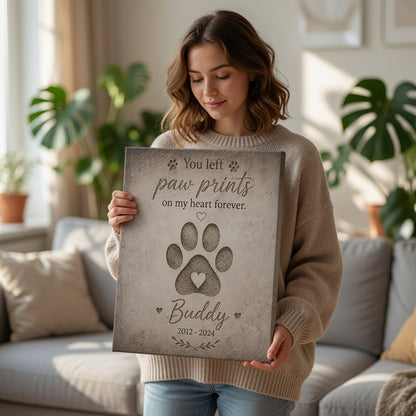 Woman holding personalized paw print memorial canvas with pet name Buddy and memorial dates