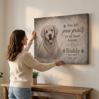 Woman hanging personalized dog memorial canvas with You left paw prints on my heart forever quote